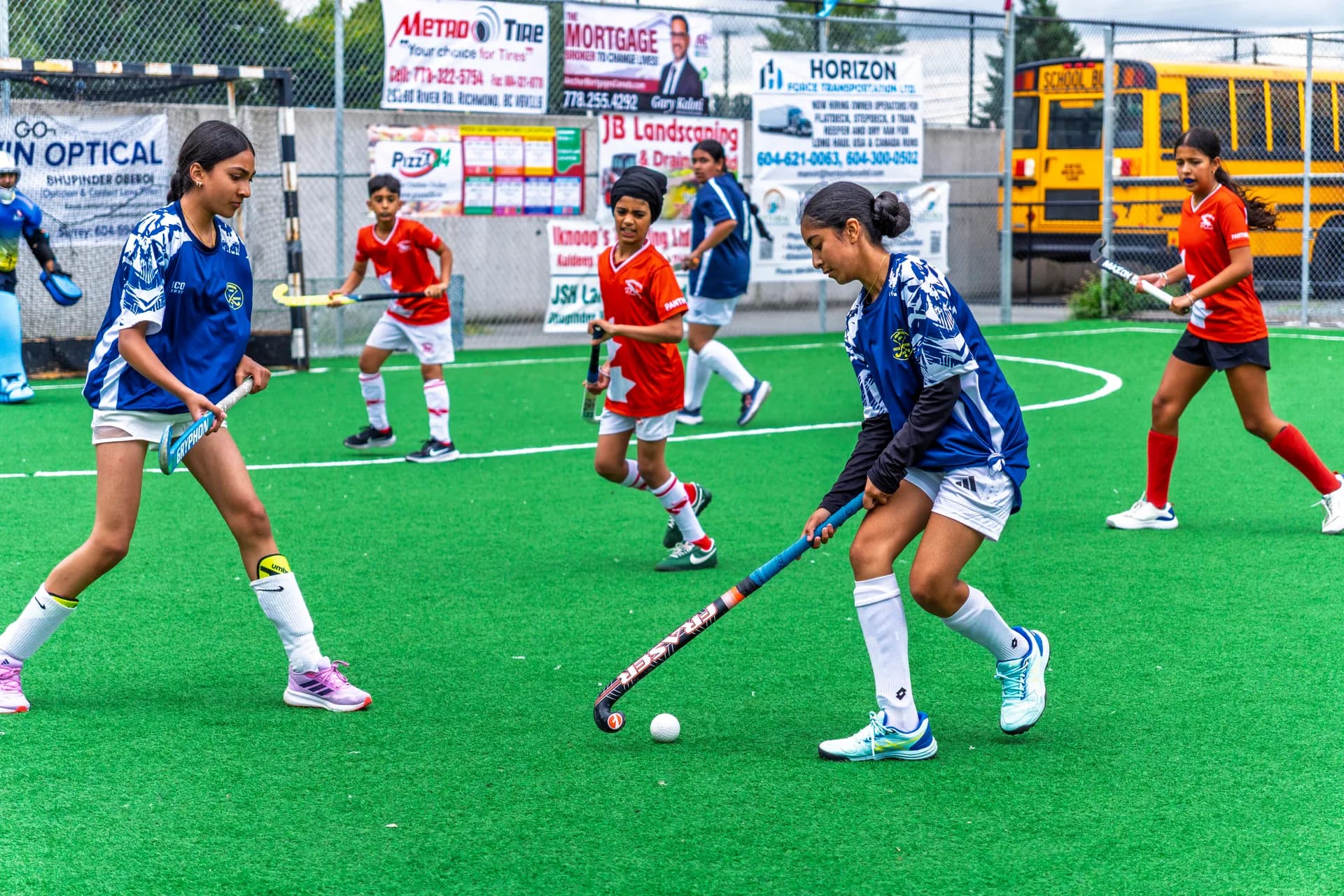 AFHC players competing for the ball during a field hockey match in Abbotsford, BC